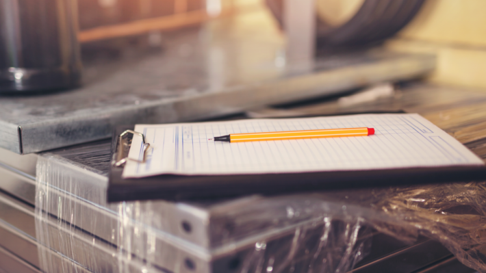 clipboard with pencil resting on top